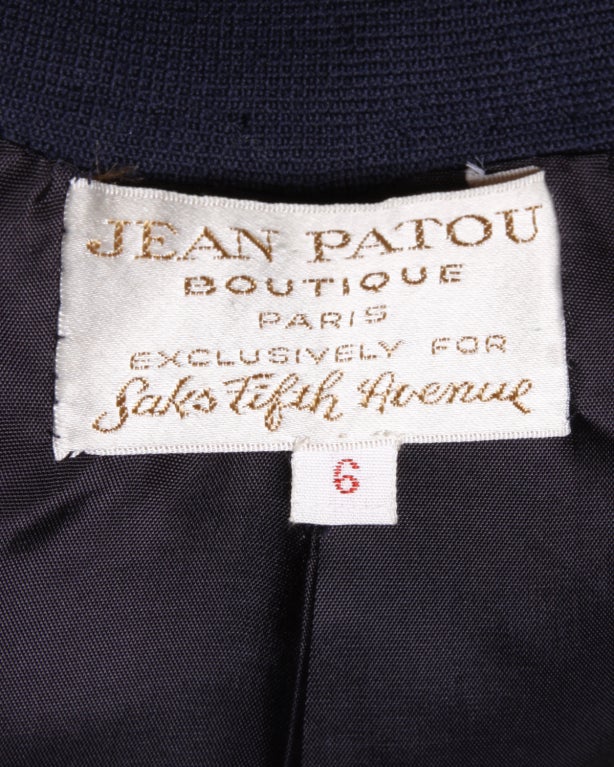 Pristine 1960's navy blue wool suit by Jean Patou for Saks 5th Avenue. This is the kind of tailoring that is a marvel to see in person! Clean lines with no stitch out of place. The interior navy lining has been carefully hand stitched into place by