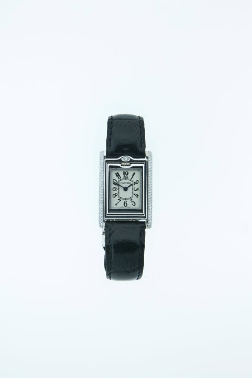 An 18k white gold and diamond Millenium lady's watch, the rectangular Basculante flip case with 