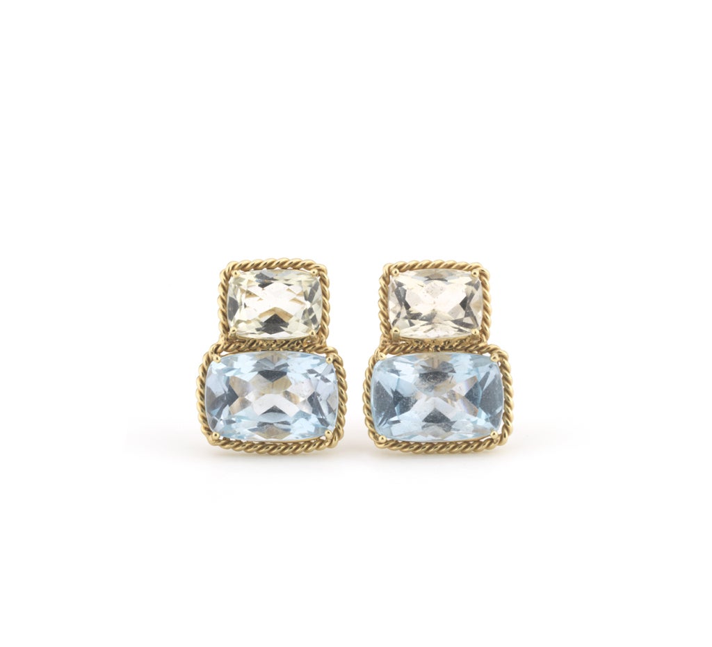 18kt yellow gold two stone earrings with rope twist border with with faceted cushion cut green amethyst and blue topaz.  The Earrings are 3/4