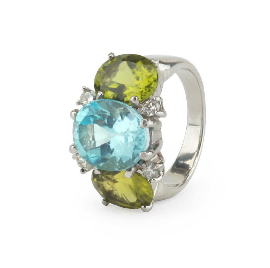 Medium 18kt white gold GUM DROP™ ring with blue topaz (approximately 5 cts), peridot (approximately 4 cts each), and 4 diamonds weighing 0.48 cts.

Specifications: Length: 7/8