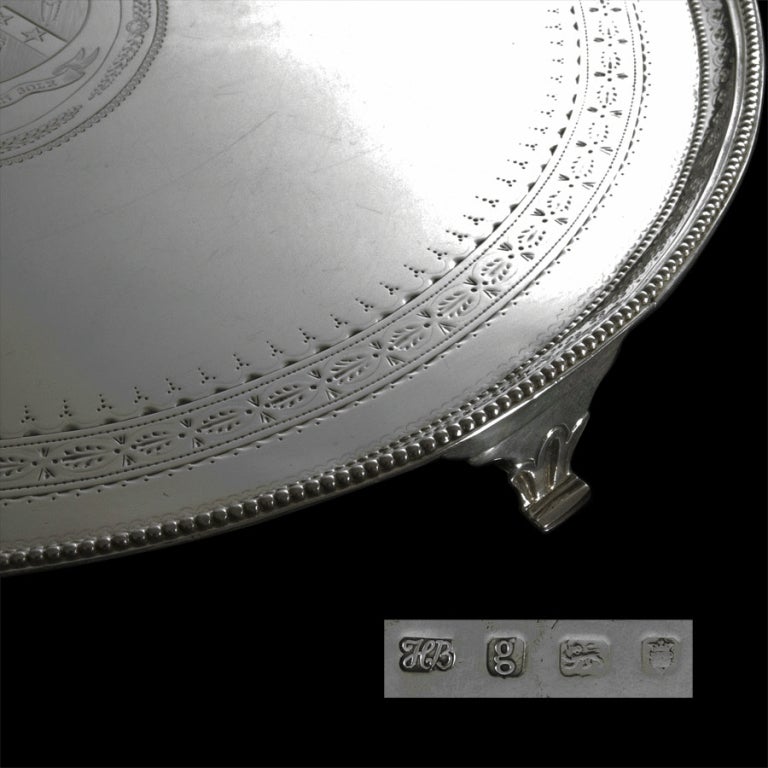 A Hester Bateman 14¼inch; silver circular salver waiter with beaded border and decorated with superb bright-cut engraving standing on four cast feet. The centre finely engraved with an heraldic coat of arms.
Signed/Inscribed/Dated: London 1782 by
