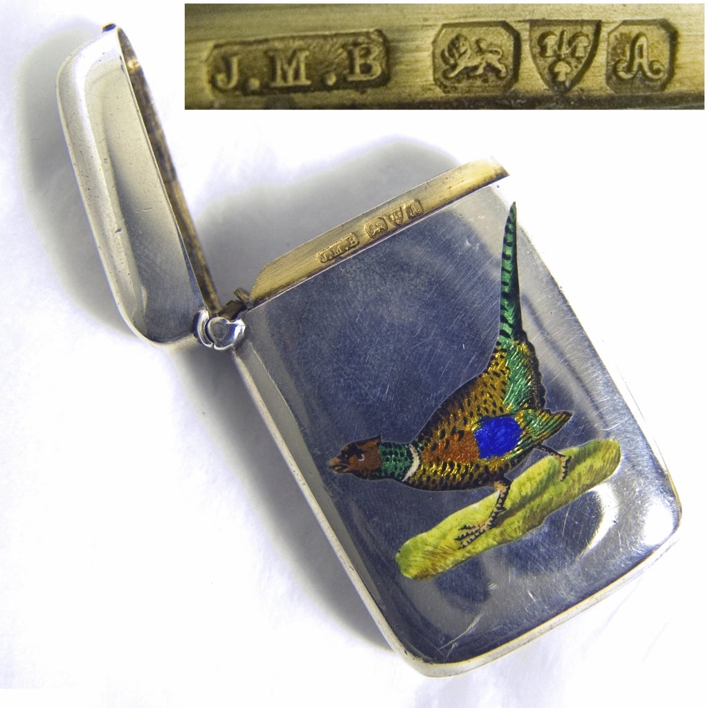 A silver and enamel vesta case depicting a pheasant.
Signed/Inscribed/Dated: Chester 1901 by John Millward Banks
