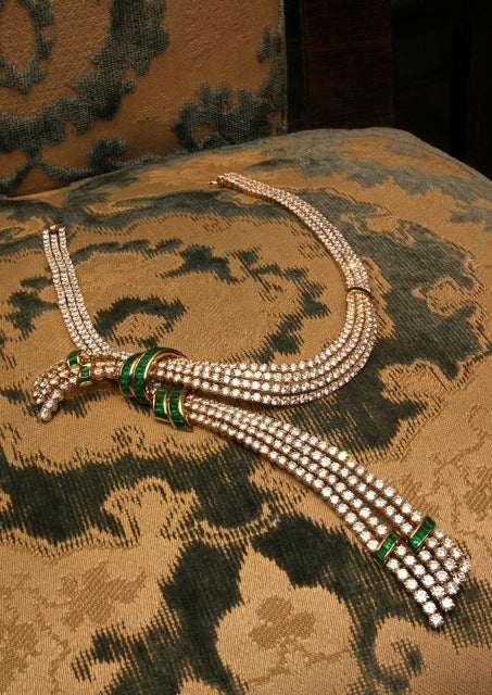 A superb necklace manufactured by Gerard, France, in the 1970s, presenting appx. 65cts of fine quality brilliant cut diamonds and appx. 10cts of emeralds, on a sophisticated cloth type 18k yellow gold mounting.