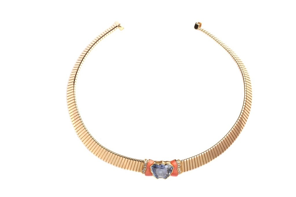 A peculiar necklace manufactured by Bulgari during the 1970s, presenting a wing shaped finely cut sapphire weighing apprx 30cts, coral and brilliant cut diamonds on a Tubogas 18kt yellow gold mounting.
