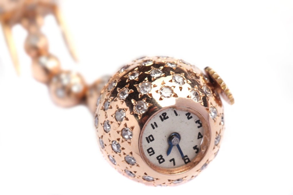 A sophisticated pin watch (modifiable as pendant) manufactured by Van Cleef & Arpels during the 1940s, presenting star decorative elements with central brilliant cut diamonds, on a fine 18k rose gold mounting.