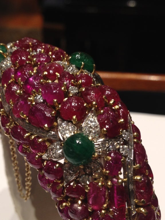 French 1940's Tutti Frutti Carved Ruby Emerald Diamond Bangle
Spectacular carved ruby, emerald, and diamond cuff. Manufactured in France in the early 1940s. Carved rubies weigh a total of 70 cts (approx), diamonds 4 cts, and emaralds 4 cts.
