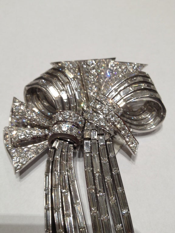 This magnificent Rene Boivin brooch, which can be separated in two clips, was manufactured by the prestigious French house in the 1940s. The item presents approximately 35 cts of excellent quality brilliant and baguette cut diamonds and is mounted