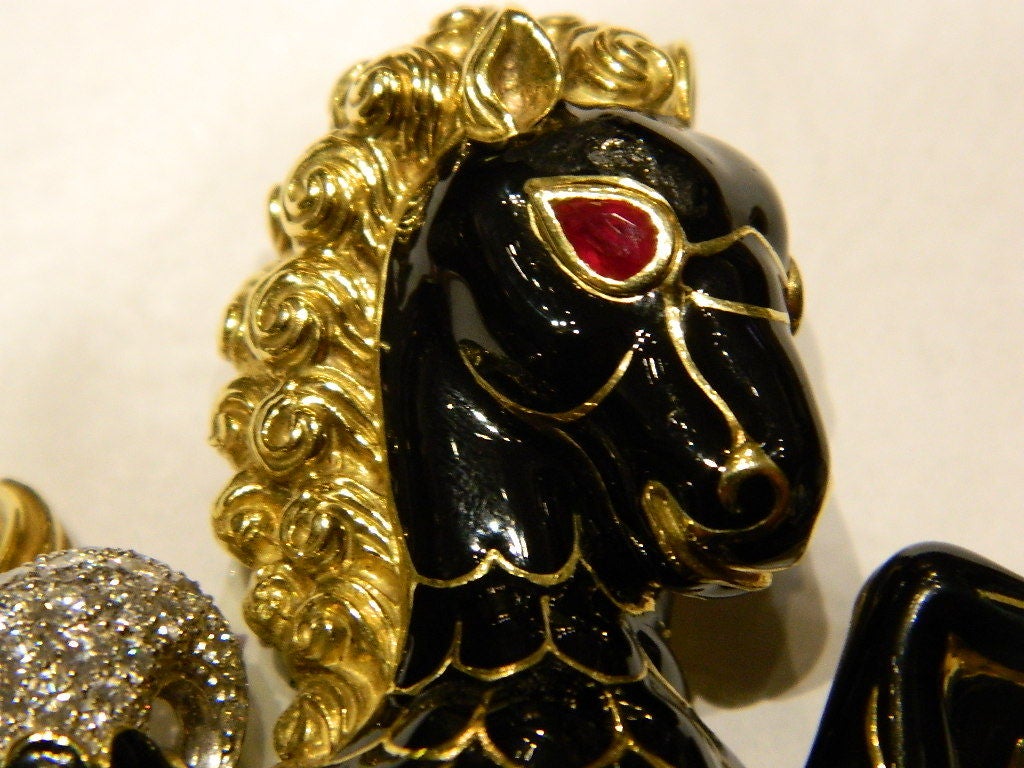 A rare brooch, representing Pegasus, manufactured by the american designer David Webb in the 1970s, presenting 2.4 cts of brilliant cut diamonds, black enamel ornaments and ruby eyes, on 18kt yellow gold and platinum mountings.