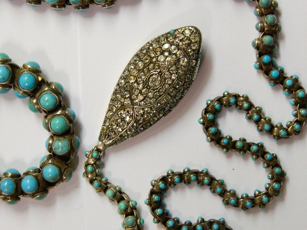 An extraordinary snake necklace manufactured during the Victorian ages, presenting approximately 7 cts of old mine cut diamonds and very fine old turquoise, on a mixed mounting in gold and silver, common of the time.