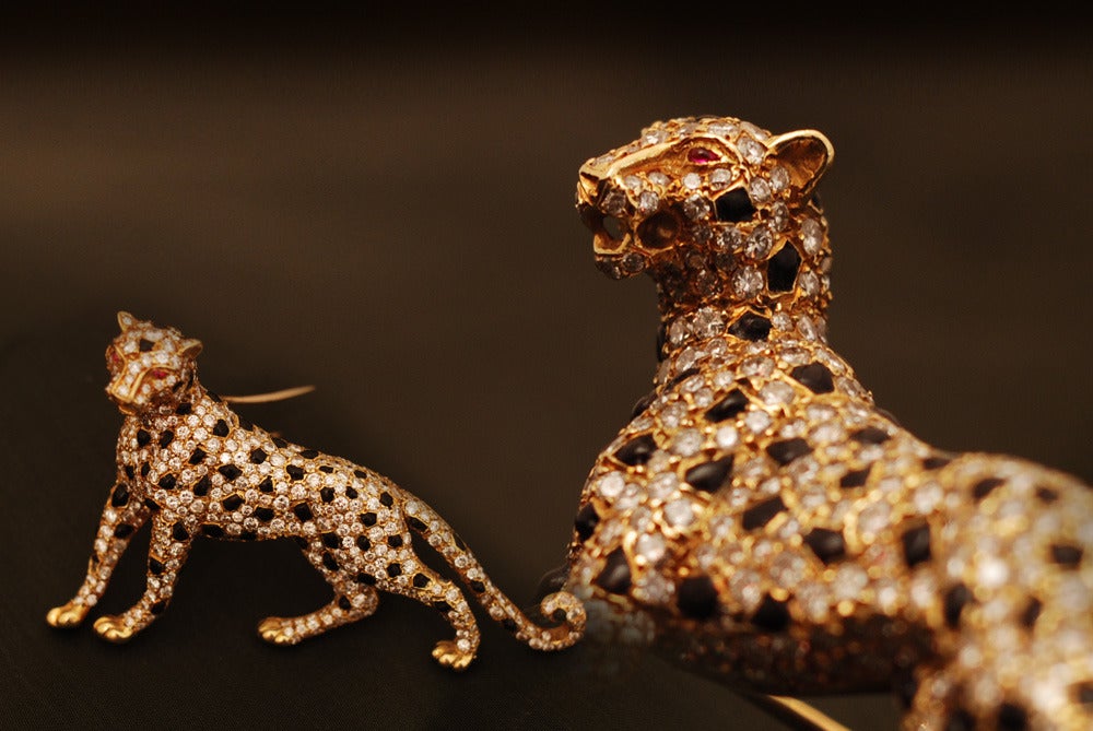 A superb everlasting panther brooch manufactured by Cartier-Paris, in the early 1980s, presenting brilliant cut diamonds and onyx on an 18kt yellow gold mounting.