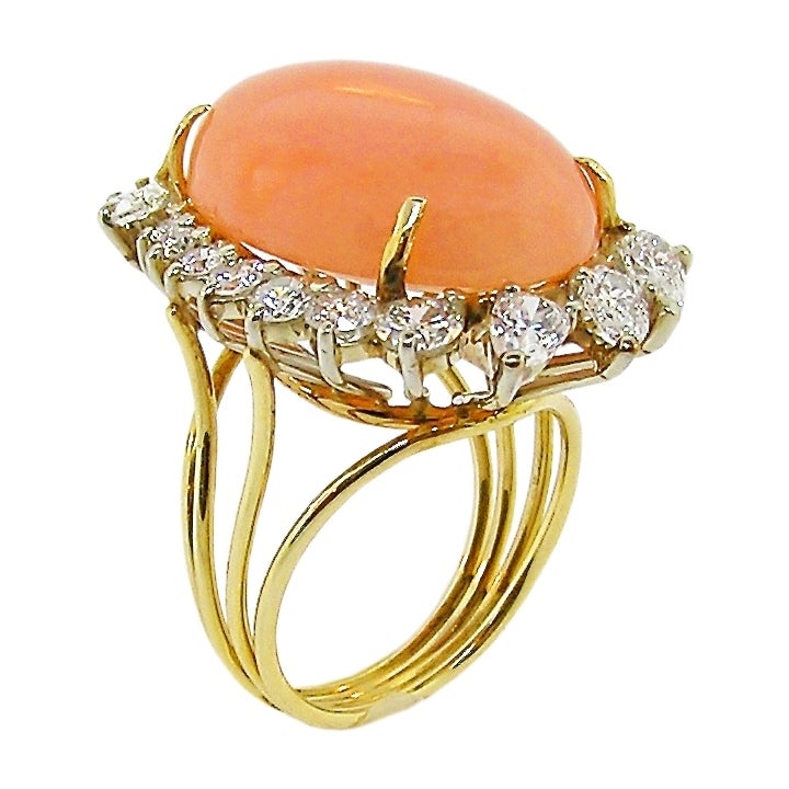 The 14K Yellow and White Gold ring hand fabricated.   Angel Skin Cabechon cut Coral of excellent quality.  The Round Brilliant and Pear Shape Diamonds of VS Clarity, G Color.  Total Weight in Diamonds is about 2.85 Carats.