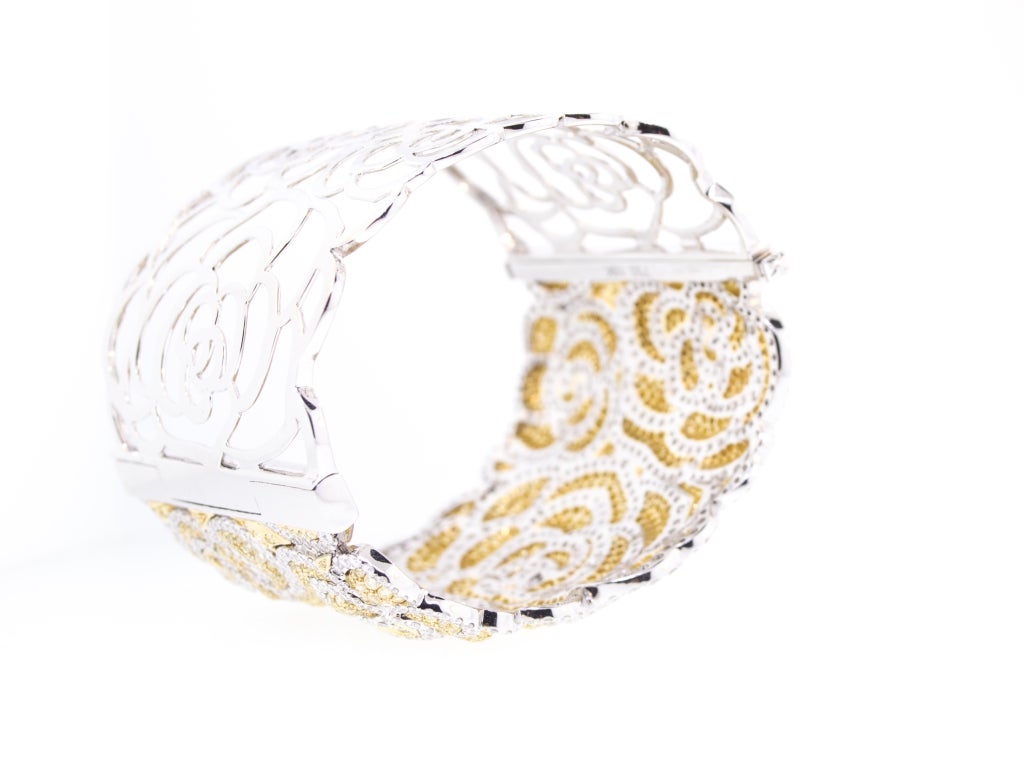 A beautiful 18K White and Yellow Gold Natural Canary and White Diamond Cuff Bracelet.  Wonderfully modeled, with the Canary Diamonds in raised bombe sections.   The floral motif continued on the pierced bottom of the bracelet.
 
23 Carats Total!