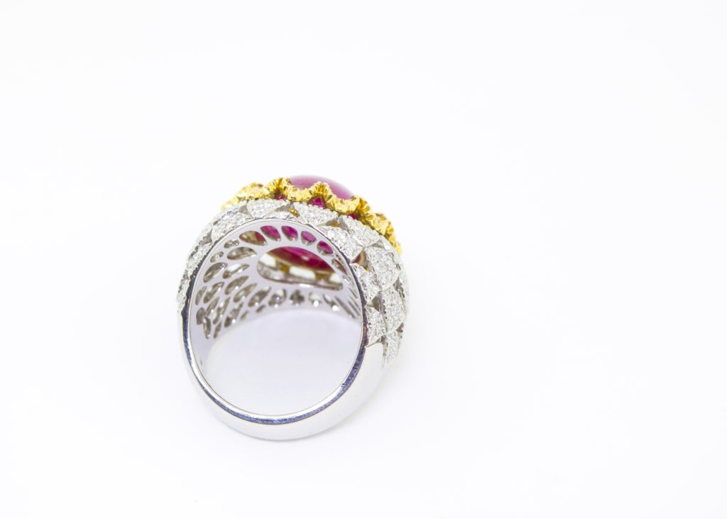 The hand fabricated Platinum and 18K Yellow Gold piece with 1.54 Carats of White and Natural Canary Diamonds.
The Burmese Cabochon Ruby is 13.70 Carats.