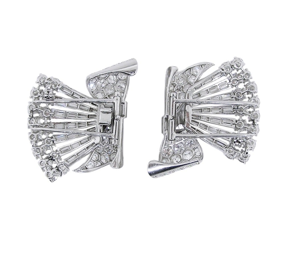Magnificent Art Deco Platinum Diamond Double Clip Brooch. 15 Carats of Round and Baguette cut Diamonds.  Exquisite craftsmanship with fully azured backs.   2 1/2 inches wide. 1 1/4 inches tall.  Circa 1930.  French.  This double-clip brooch is one