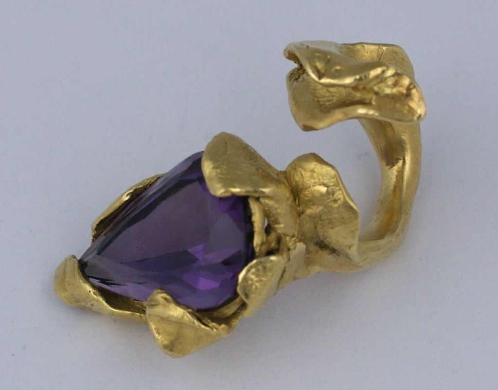 Important gold and amythest modernist ring by studio jeweler Irena Bryner. The extremely heavy 18K open shank coils around the finger and ends in a large modified pear shaped amythest. Almost snake like in its abstraction and power. Very small size,