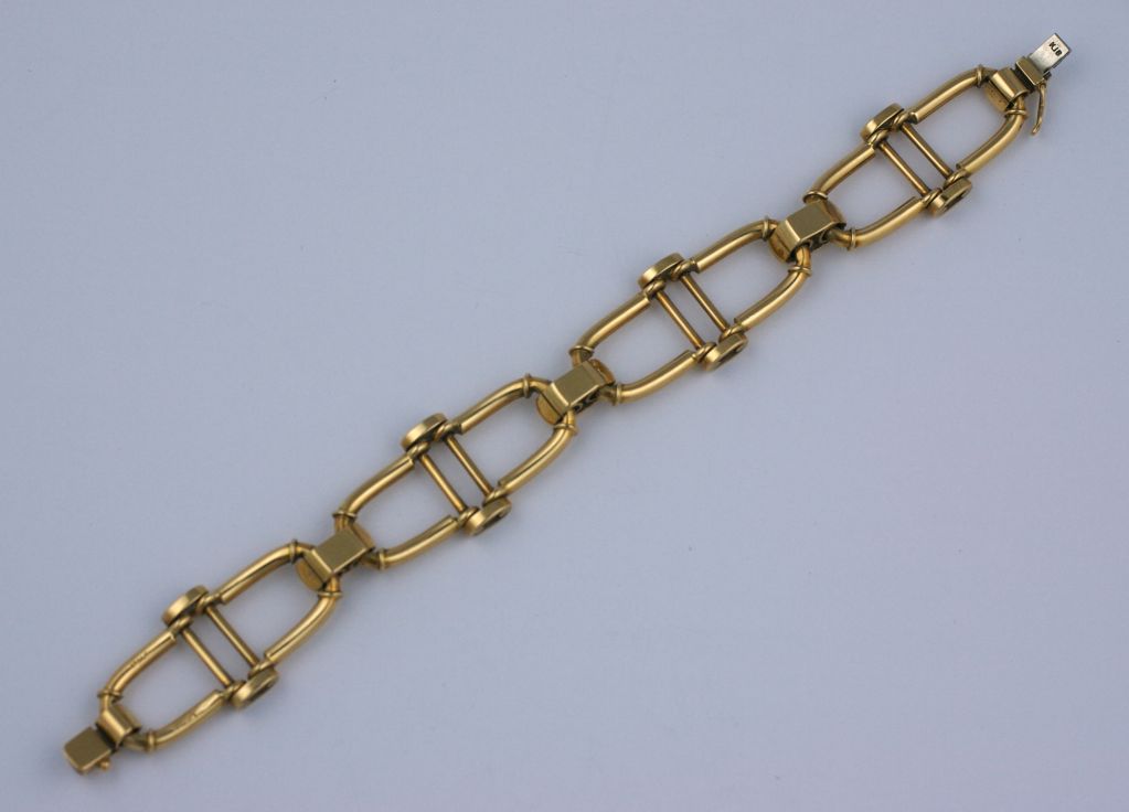 Handsome 18K bracelet by Cartier. Ribbed connectors with a equestrian styled link.
Signed: Cartier, Italy, 7" x .75".
28.8 dwt/44.6 gms.
Excellent Condition