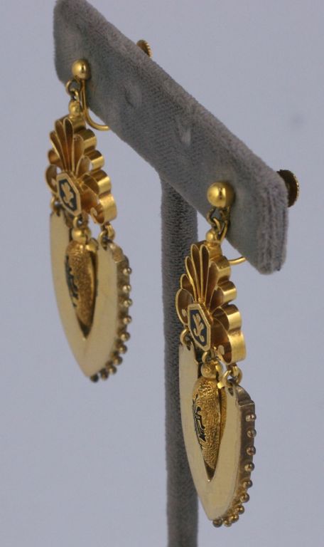 Rare Victorian earrings with mottled and shiny textures. High style urn form pendants with black enamel to match fleur de lis motifs above. Entire earring is articulated to move with wearer. Circa 1870s.<br />
Excellent condition,6cm x 2cm. Screw