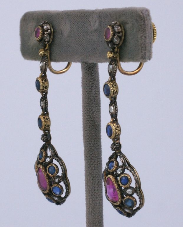 Lovely antique earrings from the end of the 19th Century. Silver topped gold with 2 large pear shaped rubies (approx 1.5 cts each) surrounded by rose diamonds and beautiful sapphires.<br />
Rubies and sapphires are set into gold settings with