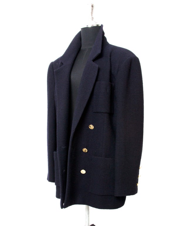 Stunning double breasted Chanel tweed blazer in dark navy blue. With broad padded 80s shoulders and pale gold 'Chanel Paris - Coco' with African elephant breasted buttons. Unique vintage piece! 

Women will love the power shoulder, but men can