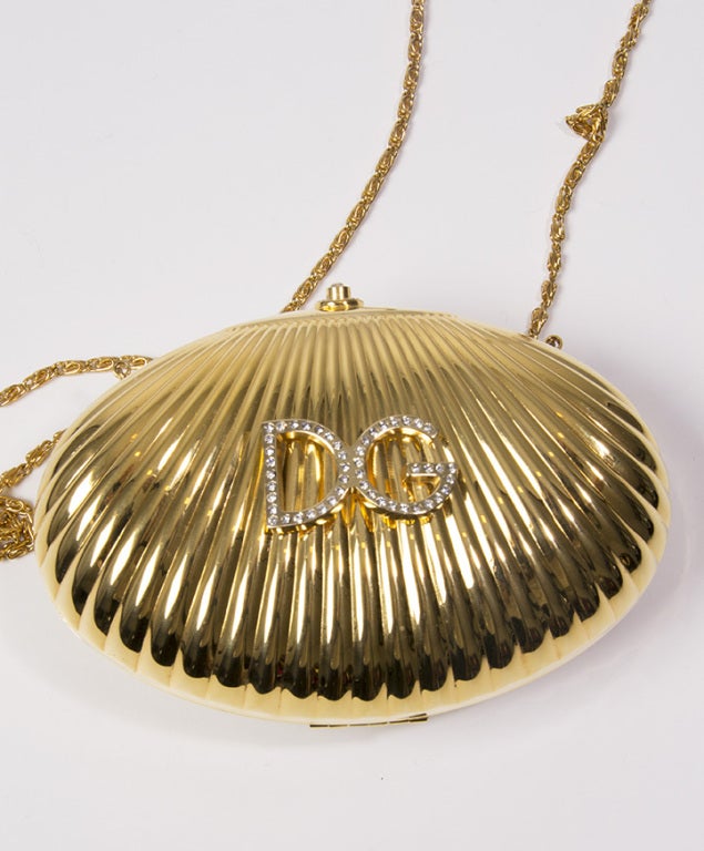 Women's Dolce & Gabbana metal shell clutch with embellished logo