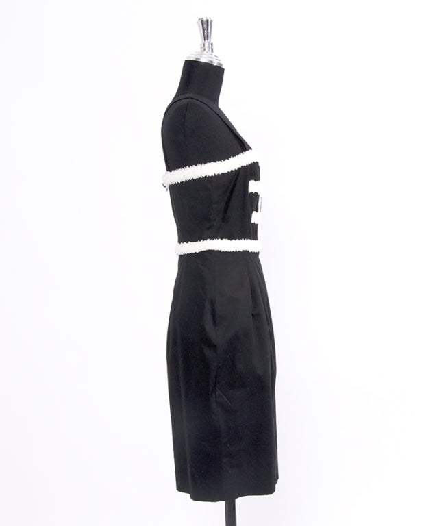 Light knee-length dress in black with white ruche details and tulip skirt. Label says 