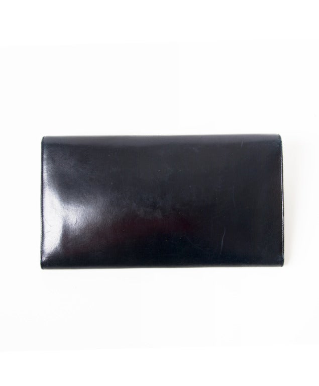 Navy Blue D leather clutch of Delvaux. Suede Inside. Logo D on the front with snap closure.