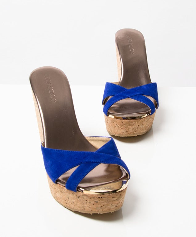 Jimmy Choo cork wedges with electric blue suede straps. Gold colored tip.

Size 37,5