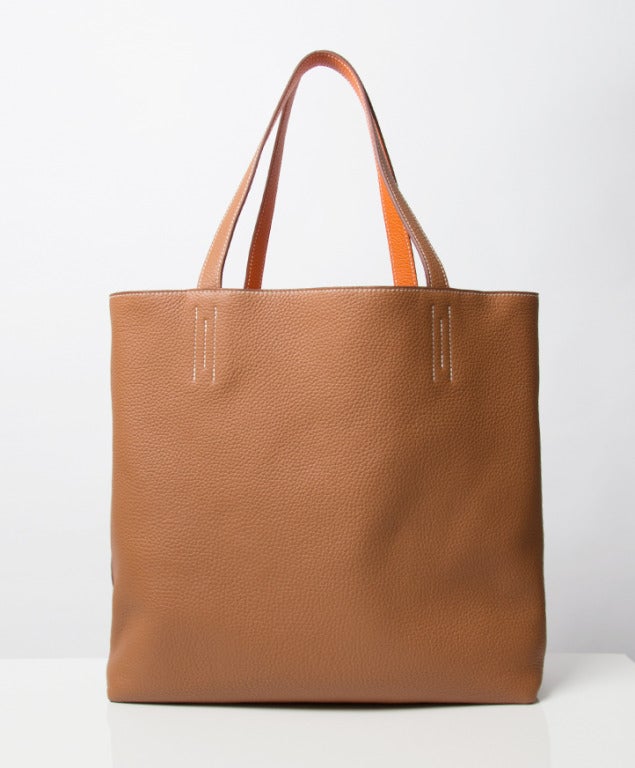 Hermes Double Sens Shopping Tote Bag. This reversible tote first came out in Fall 2010. It is a lighweight and practical bag that includes a double strap handle with narrow base. The Double Sens is the perfect understated bag for everyday wear.