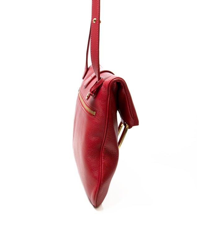 Delvaux 'Givry' red cross body bag with gold hardware. Adjustable strap. Interior pocket with zipper. Separate cellphone pocket. Zipper at the back of the bag to quickly access the bag. Comes with the original dust bag.

Retails at Barneys' New