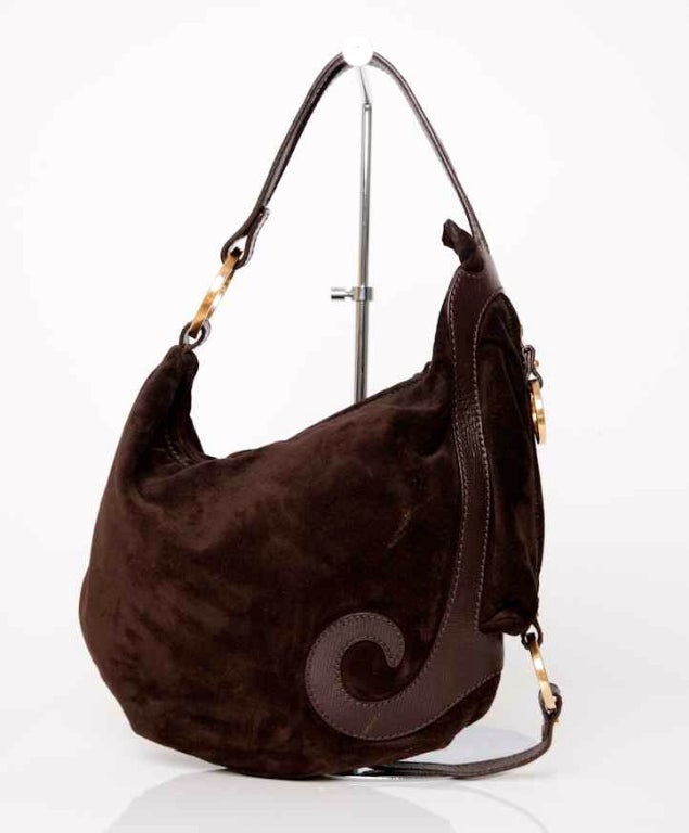Beautiful Fendi handbag made of a beautiful chocolate brown suede. The suede has a leather finish and gold tone studs and rings. The gold tone rings have 
