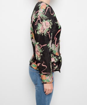 Ungaro is known for its remarkable colorful flower prints.
Although this elegant vintage jacket has more neutral colors, the typical flower print on the black linen is still very much present. 
The lightweight jacket is perfectly tailored around
