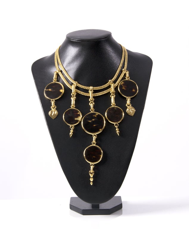 Yves Saint Laurent necklace and bracelet set featuring gold plated hardware and tortoise disk pendants. Can be worn in 2 ways: gold plated or tortoise shell side up.  Sold separately or together with matching bracelet. Gorgeous statement necklace, a