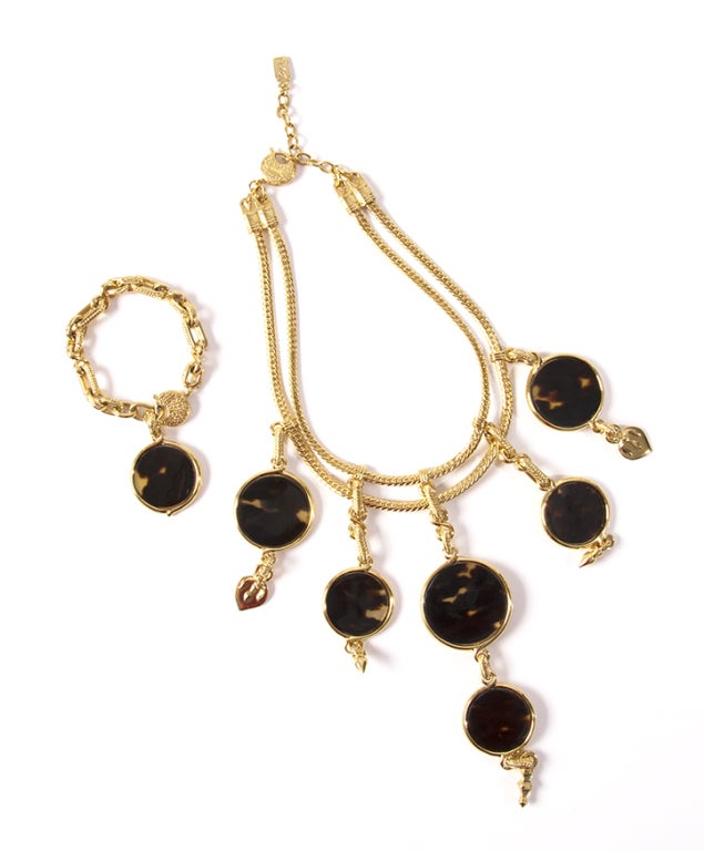 Gold plated Yves Saint Laurent Bracelet featuring tortoise shell disk charm. Sold together or separately with matching Yves Saint Laurent Tortoise Necklace. Marked on a plaque on the back of the earring that says YSL.