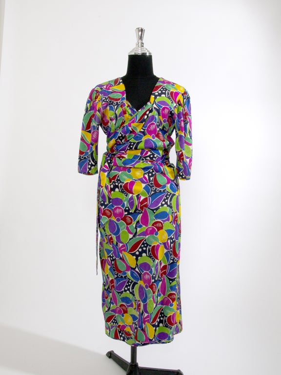 Ungaro dresses are known for their flamboyant patterns and elegant draping with an emphasis on the comfortable and flattering encasement of the female form. These dresses are truly vintage pieces. 
This is dress is a wrap exemplary with plunging