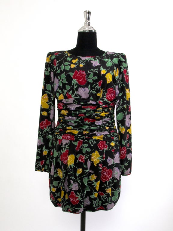 Ungaro dresses are known for their flamboyant patterns and elegant draping with an emphasis on the comfortable and flattering encasement of the female form. These dresses are truly vintage pieces. 
Black dress with red, yellow and green rose print.