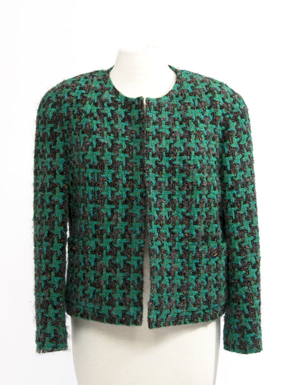 Vintage wool Chanel vest with open front in emerald green hue. This little vest reaches the hips and looks great with a pair of jeans and high top sneakers for an effortless casual look.