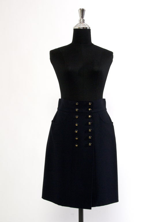Elegant Chanel skirt in dark blue hue with gold logo embossed buttons in the front. Made from wool.