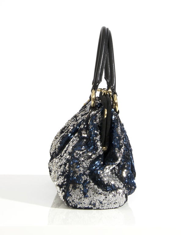 From the Spring/Summer 2010 Collection, I present to you the Marc Jacobs NY Rocker Stam! 
Marc Jacobs re-invents the iconic Stam purse with this Sequined New York Rocker Stam Bag, which boasts a very glam-rock blue and silver paillette print with