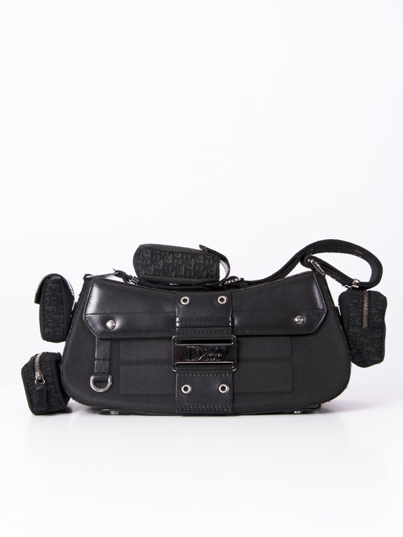 This authentic Christian Dior Street Chic handbag is ideal for an evening out to dinner or a night out on town. This bag has 4 removable side pockets.The adjustable flat shoulder strap makes it easy to carry this unique piece. The front flap