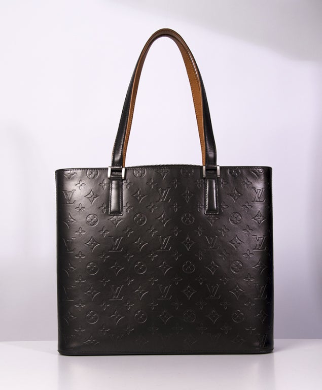 Classic brand Louis Vuitton's Director Marc Jacobs created this original Tote bag. Thick and sturdy calfskin is painted the darkest shade of satin coated brown, embossed with the famous Louis Vuitton logo.

COMES WITH 
dustbag

PLEASE NOTE
All