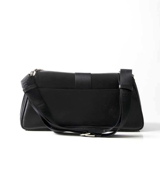 When we think about a Christian Dior hand bag, this black saddle bag comes into mind. Throughout the years Dior put out many versions of its signature saddle bag. This one features a white zircone encrusted lock and has a black coated exterior. It