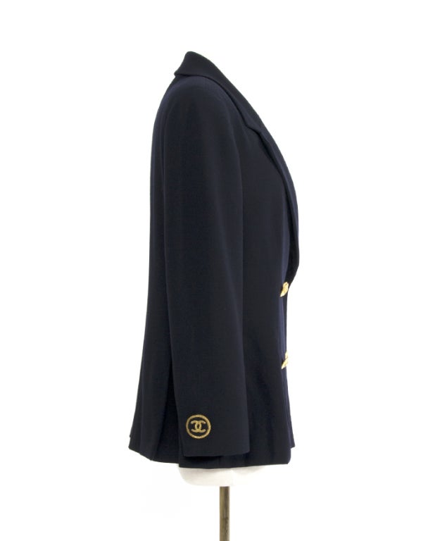 Stunning authentic Chanel blazer. An absolute eye catcher despite and because of it's elegant and sober tailoring. Navy colored with gold logo embossed buttons complete the look of timeless charm. Nice detailing on the cuffs: gold embroidered n°5 on