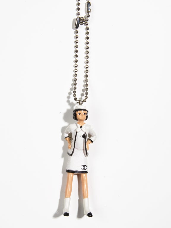 Extremely rare collector's item! 
This adorable Coco Chanel doll necklace was given only to a few VIP customers as a special gift and was never for sale in the Chanel Boutiques.

You can use the Choco Chanel doll with a shorter silver metal chain