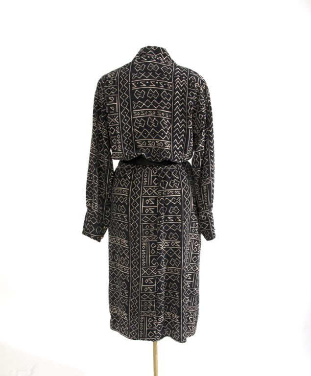 Authentic Chanel shirt dress in Noil silk. Noil looks similar to cotton, but has the soft feel of silk against the skin. It also drapes better than cotton and resists wrinkling.

The graphic sandy white on black print is ethnical inspired, giving