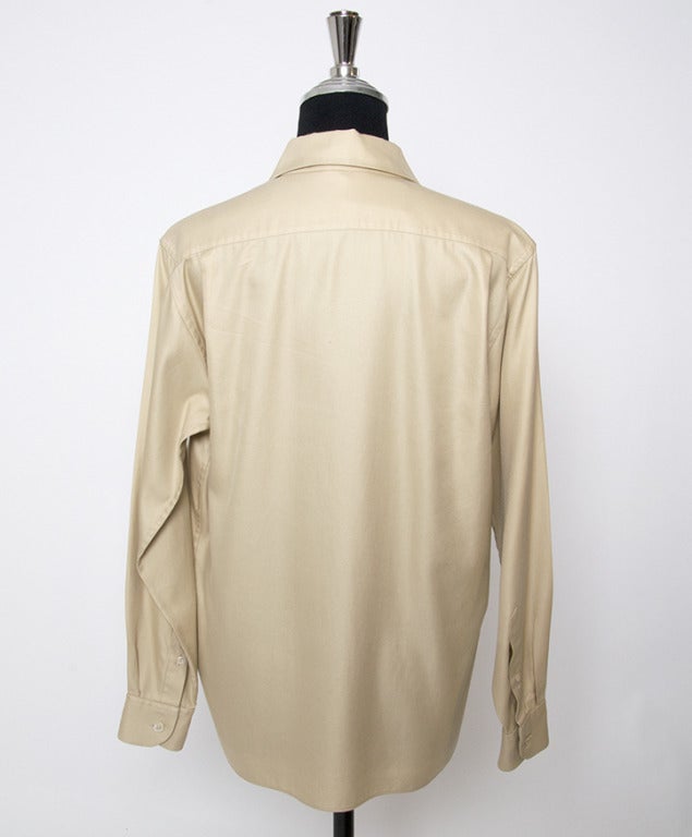 Equestrian silk shirt by Hermes Paris in elegant sandy beige hue. The shirt has a loose, nonchalant fit.