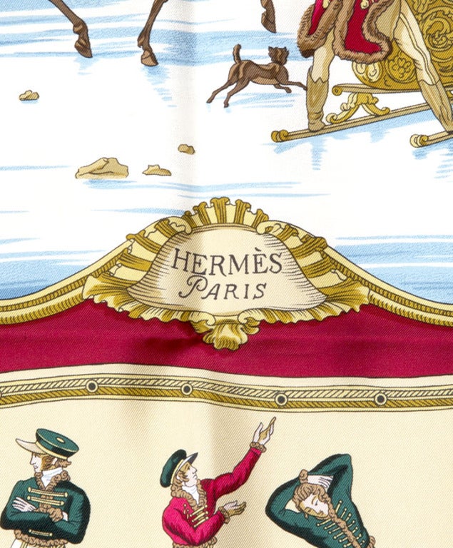 Hermes scarf made from 100% silk in sky blue, ruby red and gold hues, themed 'Les Plaisirs du Froid'.