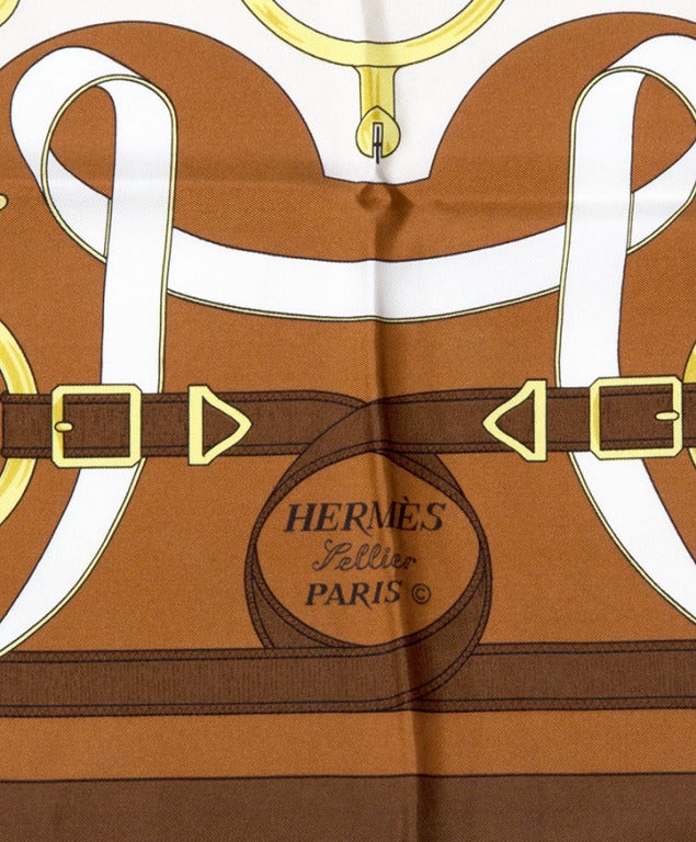 Hermes scarf made from 100% silk in signature Hermes equestrian print. Cognac and gold hues.