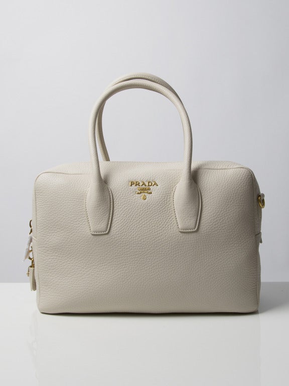 Lovely Prada Bauletto handbag with yellow gold hardware. Purchased in Firenze and never worn! Comes with authenticity card N° BL0816 and tag with same register number. 

The shoulder strap is still wrapped, as are the zippers. 

Dimensions: