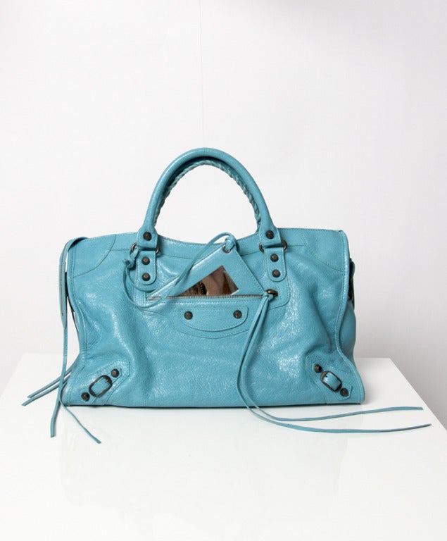 Balenciaga IT-bag! A very gently worn City Motorcycle bag in vibrant turquoise hue. One word: lovely. 

Features:
-Signature long leather tassels
-Stud accents
-Mini buckle accents at bottom corners
-Rolled double handle
-Shoulder