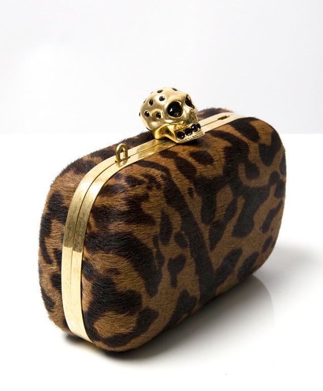 Alexander McQueen Ocelot Clutch 
Made from Pony hair
has the signature skeleton as the buckle
has the additional sling (in black)
Comes in original box and dustbag
Comees with original tag and payment barcode (from initial purchase)